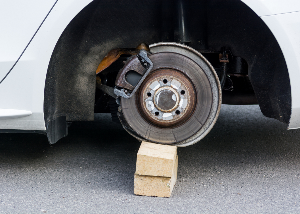 Car sitting on block with wheel stolen