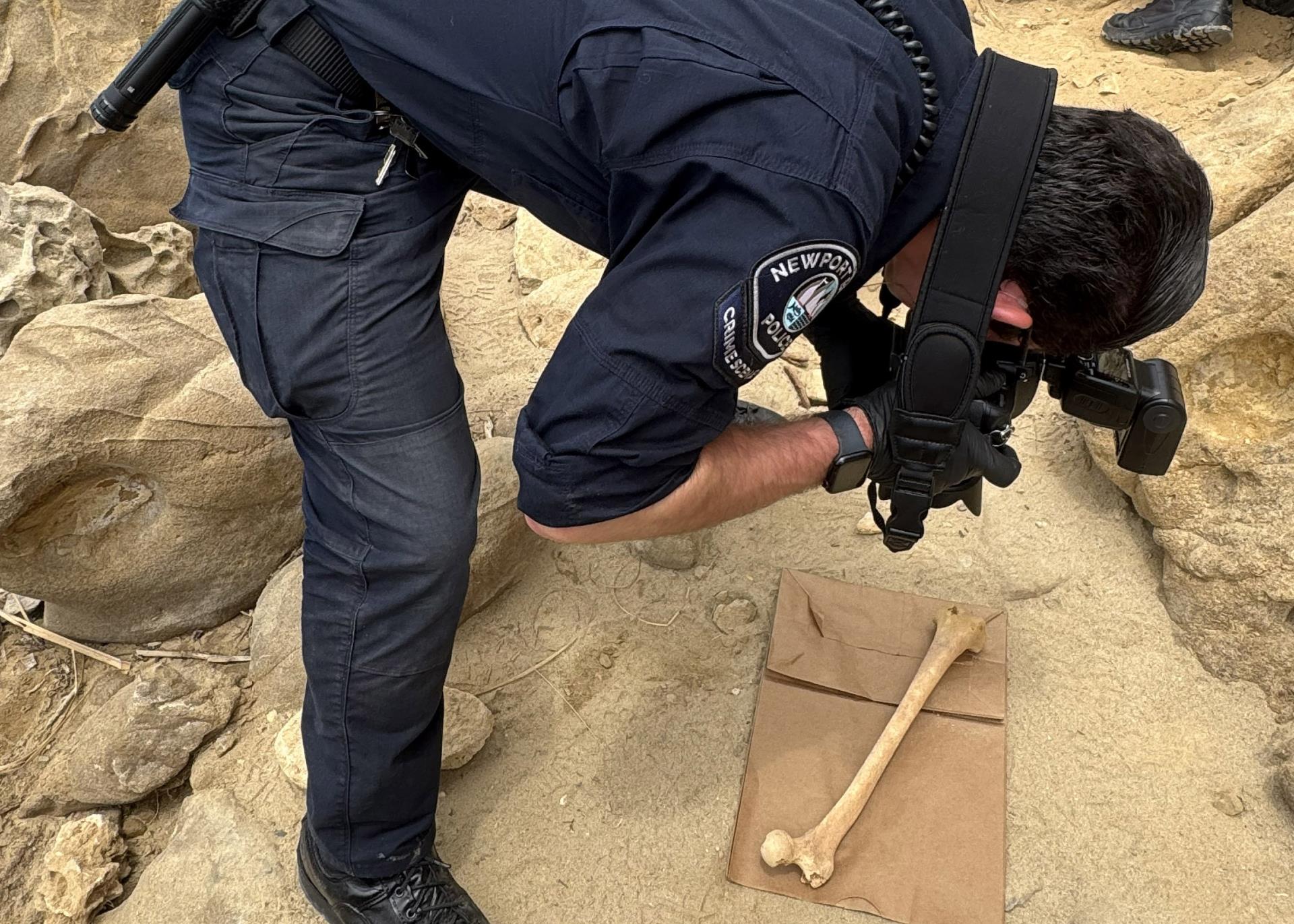 CSI photographing bone at the beach