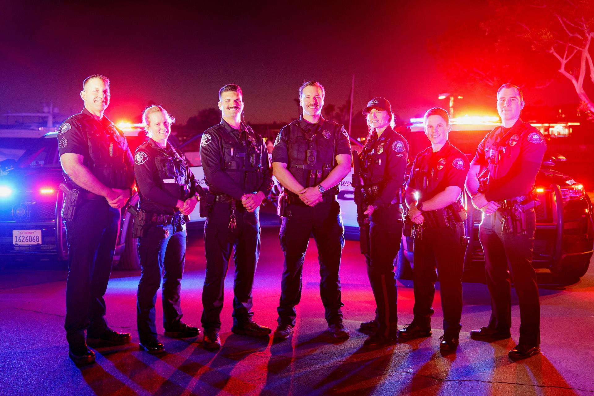 NBPD Officers in front of police car lights